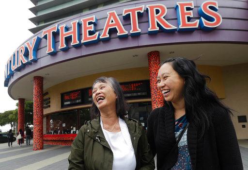 In this Thursday, Aug. 23, 2018 photo, Alice Sue, left, and her daughter Audrey Sue-Matsumoto laugh while interviewed after watching the movie Crazy Rich Asians in Daly City, Calif. It was Sue's second time watching the movie. When